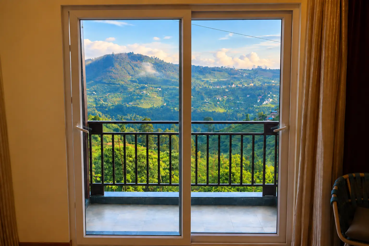 Balcony overlooking green Kodaikanal hills