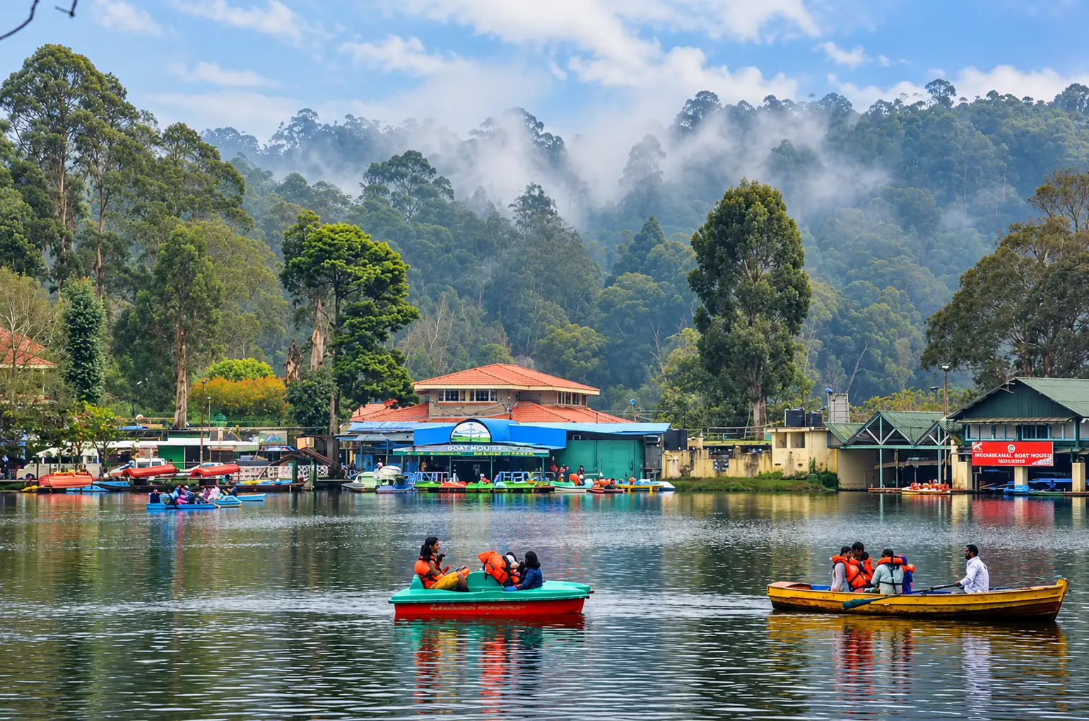 Boats on Kodaikanal Lake with wooded hills beyond